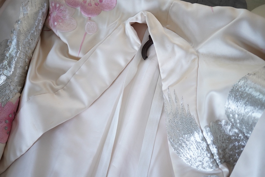 A Japanese pale pink silk floral and metallic thread bird embroidered wedding kimono, 184cm long.